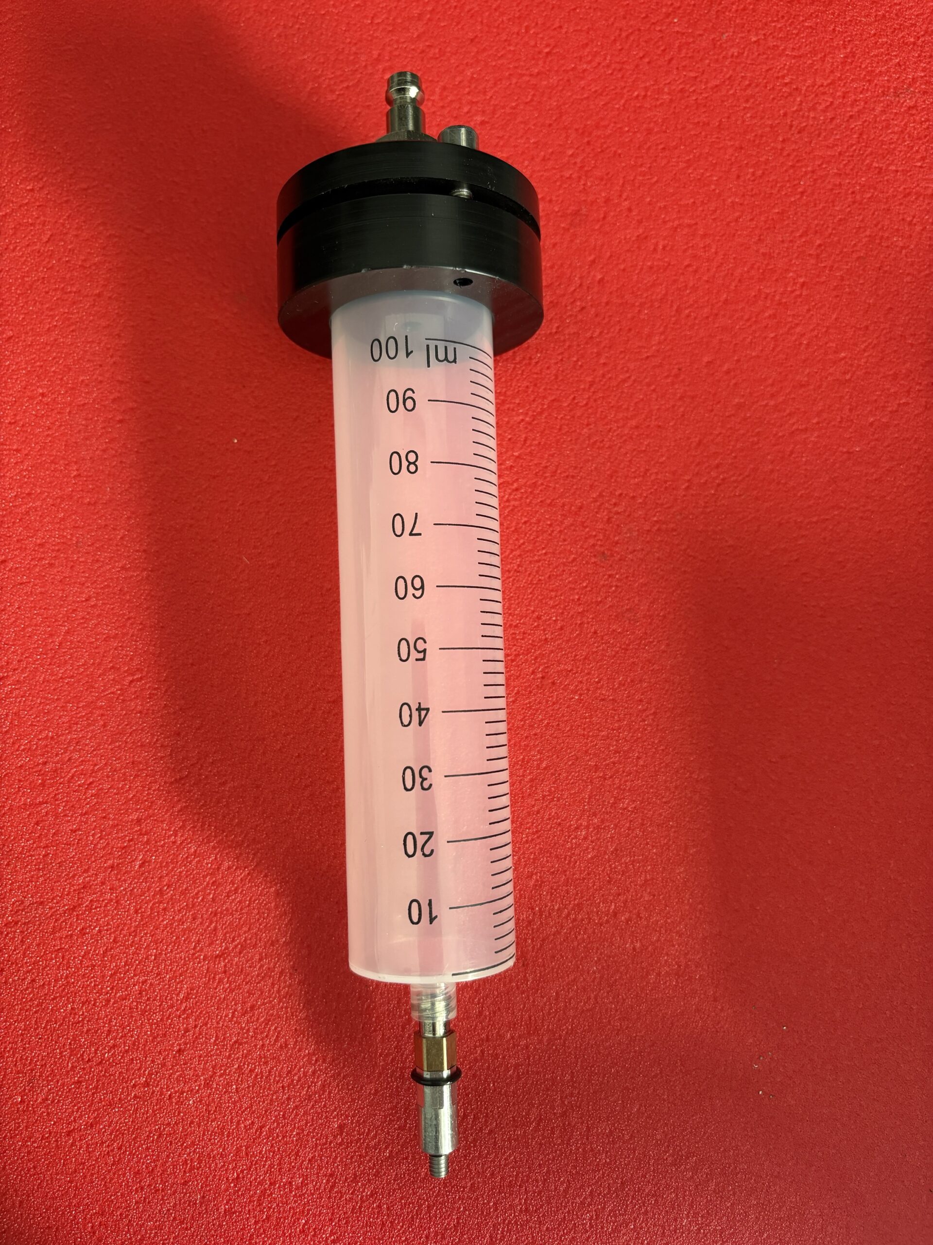 Depósito 100ml purgado y llenado. Jeringa 100ml.